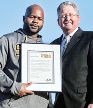 Springers Coach Loren Johnson, left, receives congratulations from Superintendent Patrick C. Kinlaw.