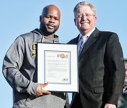 Springers Coach Loren Johnson, left, receives congratulations from Superintendent Patrick C. Kinlaw.