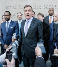 Above, U.S. Sen. Mark Warner, backed by faith leaders from the Muslim, Christian and Jewish communities, calls for religious tolerance at a news conference last Friday in Richmond. 