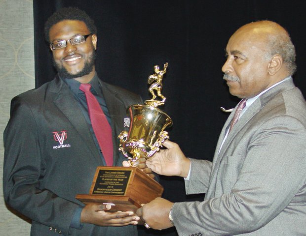 Shawheem Dowdy holds his Lanier Award with Willie Lanier.