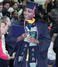 Valedictorian Destini Orr, below right, of Petersburg, savors the VSU graduation scene after receiving her degree. The university’s top scholar majored in health and physical education/sports medicine. More than 400 students were awarded undergraduate and graduate degrees at the ceremony.