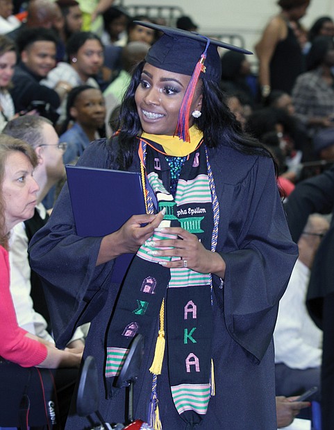 Valedictorian Destini Orr, below right, of Petersburg, savors the VSU graduation scene after receiving her degree. The university’s top scholar majored in health and physical education/sports medicine. More than 400 students were awarded undergraduate and graduate degrees at the ceremony.