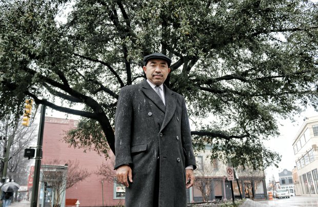 
Gary L. Flowers stands Wednesday in front of the oak tree he wants removed from the site of the proposed Maggie L. Walker statue. Location: Broad and Adams streets at the intersection with Brook Road, a gateway into Jackson Ward, the historic center of Richmond’s black community.