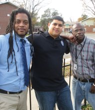 Richmond Police Officer Reynaldo Perez is flanked by Shaun Moore, left, and Jeffrey Perry, who found jobs after participating in Bridging The Gap One Human At A Time, a program the officer started. Location: Mosby Court public housing community.