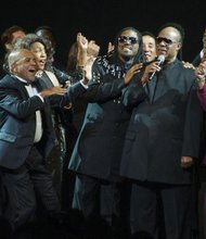Actor and singer Elijah Ahmad Lewis, center, is flanked by Berry Gordy Jr., left, and legend Stevie Wonder as he and fellow cast members of “Motown: The Musical” celebrate the show’s national tour in late 2014 in Detroit, the home of Motown. Mr. Lewis portrays Mr. Wonder in the show that opens Jan. 5 in Richmond at the Altria Theater.