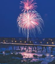 Fireworks light up the sky and glow in the James River during the Fourth of July celebration at Brown’s Island in Downtown.
