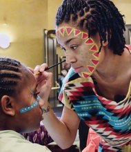 Colorful Kwanzaa festival //
Kiran Bhagat paints the face of Jailynn Dames during the Capital City Kwanzaa Festival last Saturday at the Altria Theater. The annual event, sponsored by the Elegba Folklore Society, drew scores of people to the festivities celebrating seven values of African culture that contribute to building and reinforcing family, community and culture.