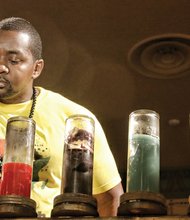 Marking Kwanzaa // Above, Joel Martinez lights the second candle of the kinara, the candleholder used in Kwanzaa celebrations, representing kujichagulia, which means self-determination in Swahili. Festival-goers enjoyed musical performances, workshops, a film festival, an African market with clothing and jewelry, African-inspired cuisine, children’s activities and a keynote address by Dr. Phil Valentine, founder, director and pastor of the Temple of the Healing Spirit — Self Education Center, and co-founder of the Institute for Self Mastery.