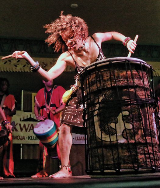 Marking Kwanzaa //
Casy Jones with the Elegba Folklore Society, left, provides a rhythmic beat of drums Saturday to mark the celebration of the 29th Annual Capital City Kwanzaa Festival at the Altria Theater. 