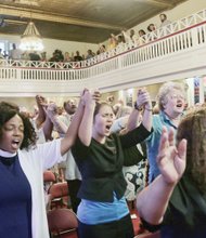 Worshipers sing “We Shall Overcome” at a unity rally in June at Third Street Bethel AME Church in Downtown following the fatal shooting in Charleston, S.C., of nine African- American church members and their pastor by a white supremacist.