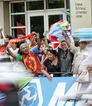 Fans from the African nation of Eritrea wave their nation’s flag as cyclists competing in the UCI Road World Championships speed past them in Downtown in September.