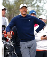 
Tiger Woods waits during a practice round at the Waste Management Phoenix Open golf tournament in January 2015. Because of poor scores, he didn’t qualify to play in the tournament’s final two rounds.