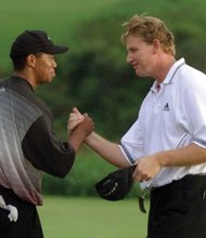 
Tiger Woods greets Ernie Els on the 18th green of the Mercedes Championships in Kapalua, Hawaii, in January 2000, after they both sank eagle putts to force a playoff. At 24, Woods won on the second playoff hole for his fifth consecutive PGA Tour victory and the 14th of his young career.  