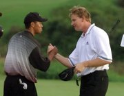 
Tiger Woods greets Ernie Els on the 18th green of the Mercedes Championships in Kapalua, Hawaii, in January 2000, after they both sank eagle putts to force a playoff. At 24, Woods won on the second playoff hole for his fifth consecutive PGA Tour victory and the 14th of his young career.  