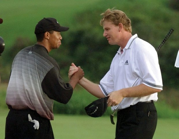 
Tiger Woods greets Ernie Els on the 18th green of the Mercedes Championships in Kapalua, Hawaii, in January 2000, after they both sank eagle putts to force a playoff. At 24, Woods won on the second playoff hole for his fifth consecutive PGA Tour victory and the 14th of his young career.  