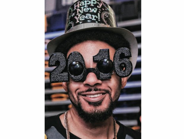 Ringing in the New Year // Charles Johnson, right, turned out in New Year’s gear, including celebratory eyewear, to party with the crowd to live entertainment. Organizers moved the previously free city event from its prior locations at Brown’s Island and Carytown to the Siegel Center and charged a fee