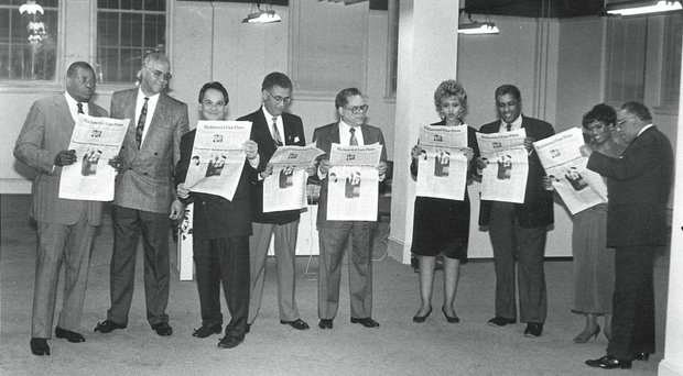 Celebrating 24 years // Checking out the Free Press //

Clinton A. Strane/Richmond Free Press
Officers and members of the board of directors of Paradigm Communications Inc., the parent company of the Richmond Free Press, check out a prototype of the new newspaper in its newsroom located in Downtown. From left, the late Dr. Allix B. James, Dr. Elwood Boone Jr.; the late Free Press founder Raymond H. Boone Sr., president and CEO; the late Dr. Darrel Rollins, board secretary; the late Dr. William S. Thornton, board chairman; Beverly Davis; the late Leonard Lambert, board treasurer; Dr. Lerla Joseph; and Clarence L. Townes Jr. This photograph was published on the front page of the Free Press debut edition Jan. 16-18, 1992.
