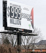 Slices of life and scenes in Richmond //
This billboard is overwhelmed by the historic size of the Powerball jackpot ahead of Wednesday’s drawing. The sign shows the jackpot at $999 million because there are not enough number slots to show the full amount, about $1.5 billion. Location: the 1300 block of Dinneen Street on North Side. Millions of hopefuls purchased tickets this week for the chance of being struck by luck and becoming a billionaire. The chances of winning are 1 in 292 million.