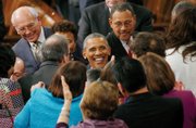 
Members of Congress enthusiastically greet President Obama as he arrives in the House of Representatives to deliver his State of the Union address.