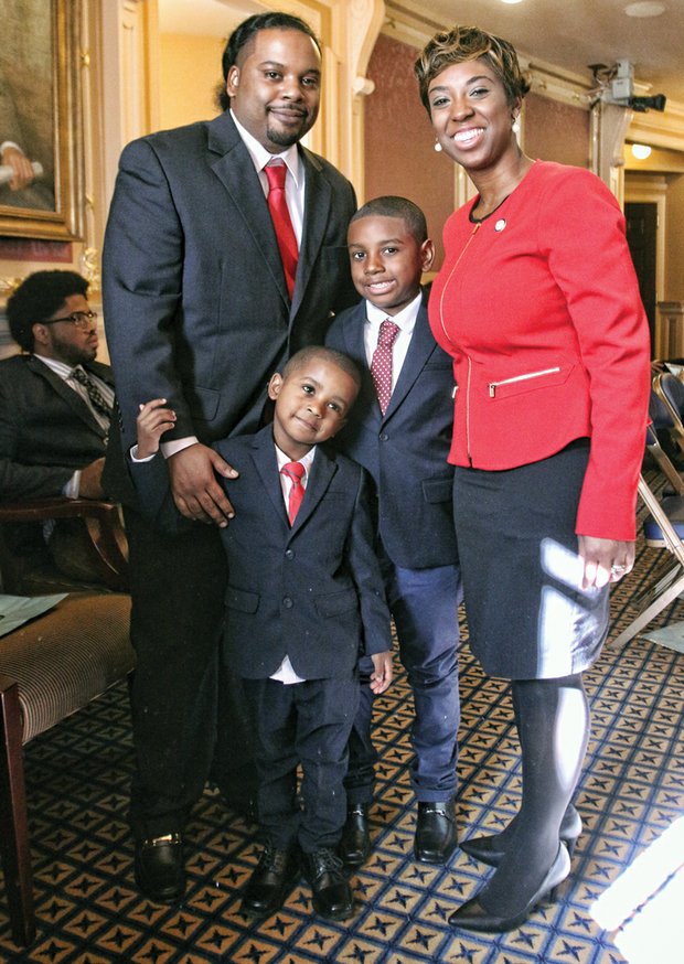 Lady of the House //
Freshman Delegate Lashrecse Aird enjoys a moment
with her family on the opening day of the 2016 Virginia General Assembly session. With her Wednesday are her proud husband, Blaine Aird, and their children, Blake,
left, and Blaine Jr. The Petersburg Democrat was sworn
in Wednesday to her first term in the House. Elected in November, she represents the 63rd House District, which also includes parts of Hopewell and Chesterfield and Dinwiddie and Prince George counties. State lawmakers will meet at the Capitol through mid-March to grapple with major issues, including a new two-year state budget.