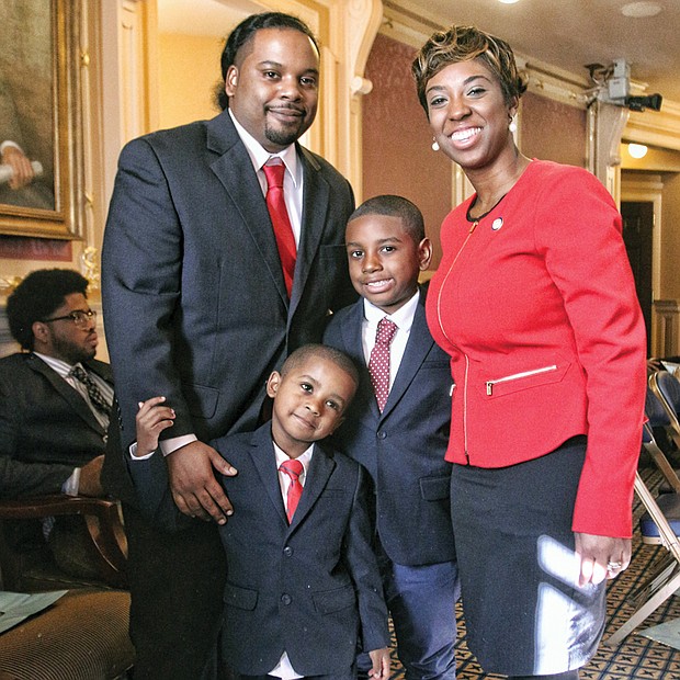 Lady of the House //
Freshman Delegate Lashrecse Aird enjoys a moment
with her family on the opening day of the 2016 Virginia General Assembly session. With her Wednesday are her proud husband, Blaine Aird, and their children, Blake,
left, and Blaine Jr. The Petersburg Democrat was sworn
in Wednesday to her first term in the House. Elected in November, she represents the 63rd House District, which also includes parts of Hopewell and Chesterfield and Dinwiddie and Prince George counties. State lawmakers will meet at the Capitol through mid-March to grapple with major issues, including a new two-year state budget.