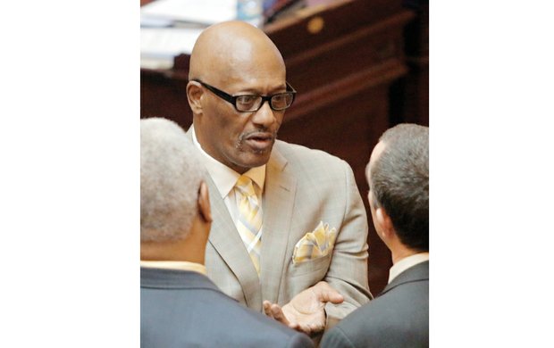 Charlie Stukes, one of seven 2016 inductees into the Virginia Sports Hall of Fame, talks with state Sen. A. Donald McEachin of Henrico County, left, and Lt. Gov. Ralph Northamon Tuesday at the General Assembly, where the inductees were recognized.