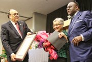 Virginia Union University President Claude G. Perkins, left, and Dr. W. Franklyn Richardson, chairman of the VUU Board of Trustees, present the MLK Lifetime of Service Award to VUU alumna Florence Neal Cooper Smith of Richmond for her work on sickle cell anemia testing and awareness in Virginia and across the nation.
