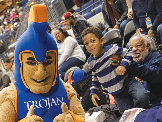  High spirit at Freedom Classic//Trojans fan Charles Garnett gives his 4-year-old great-grandson Jeremiah Marte a lift as the VSU mascot rallies the fans. 