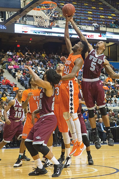 High spirit at Freedom Classic // VUU’s Danny McElroy goes high to block a shot by VSU’s Elijah Moore. Fans for both teams enthusiastically cheered the action