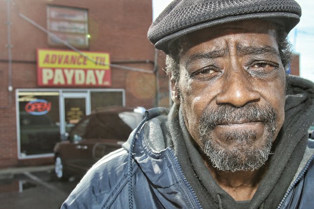 
Donald Garrett stands outside the Advance ‘Til Payday loan agency, 4311 Nine Mile Road, where he borrowed $100. The loan ended up costing him $320 in fees he could not afford on his fixed income.