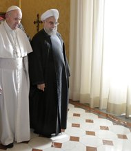 Pope Francis and Iran President Hassan Rouhani chat Tuesday during a stroll through the Vatican. 