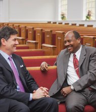 Dr. Reginald F. Davis, right, pastor of First Baptist Church, shares a moment with Mitchell B. Reiss, president and CEO of the Colonial Williamsburg Foundation, inside the historic African-American church in Williamsburg.