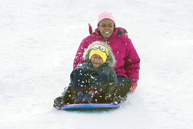 School’s out, sledding’s in //
Jeramia Thomas, 5, closes his eyes to the action as he and Christina Williams, 12, sled down the slopes Monday at Richmond’s Forest Hill Park. With schools and businesses closed, they joined others who took advantage of the Richmond area’s first big snowstorm of the season to go sledding, build snowmen and have snowball fights. The National Weather Service estimated that between 11 and 16 inches of snow fell in Metro Richmond.