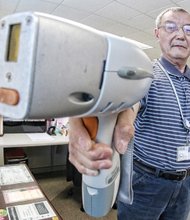 Inspector Ben Yan shows how the lead detector instrument works during a demonstration Wednesday in his office at the Richmond City Health District.