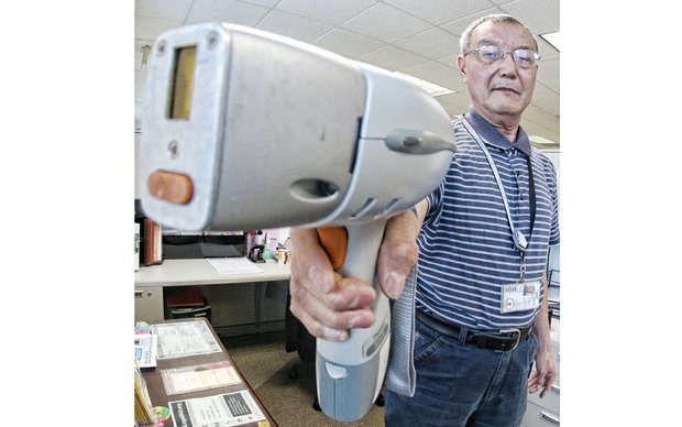 Inspector Ben Yan shows how the lead detector instrument works during a demonstration Wednesday in his office at the Richmond City Health District.