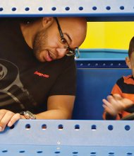 In the driver’s seat Mason Whitaker, 2, gives his father, Richard Whitaker, a driving lesson as they played in a toy car Wednesday at the Children’s Museum of Richmond. enjoying the day with dad, Mason enjoyed activities
that both expand
the imagination and learning.