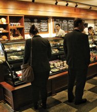 Café and bakery debuts at theater // Customers browse at the new 1927 Café and Bakery inside the Altria Theater at Main and Laurel streets across from Monroe Park. The shop opened last week and offers breakfast, lunch and evening bistro fare, along with teas and coffee. The café is open seven days a week to the public and provides additional food and beverage options for show attendees. The name pays tribute to the year when a Masonic group opened the building as The Mosque.