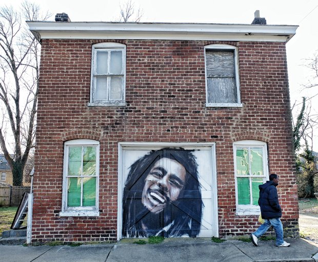 Cityscape // Slices of life and scenes in Richmond
A pedestrian passes this tribute to the late great reggae master Bob Marley. Perhaps this homeowner was inspired to add some garage door art by all of the large murals popping up in Richmond. Location: 13th Street between Bainbridge and Porter streets in South Side.