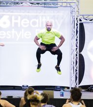 
Fitness fun //
Nationally known fitness guru Shaun T, whose exhilarating dance workouts and fitness routines help people across the country, leaps high in the air last Saturday during a group workout at the 14th Annual CBS 6 Healthy Lifestyle Expo. Hundreds of fitness seekers from Metro Richmond participated in the event at the Greater Richmond Convention Center, which included presentations from other health experts, health screenings and healthy cooking demonstrations. 