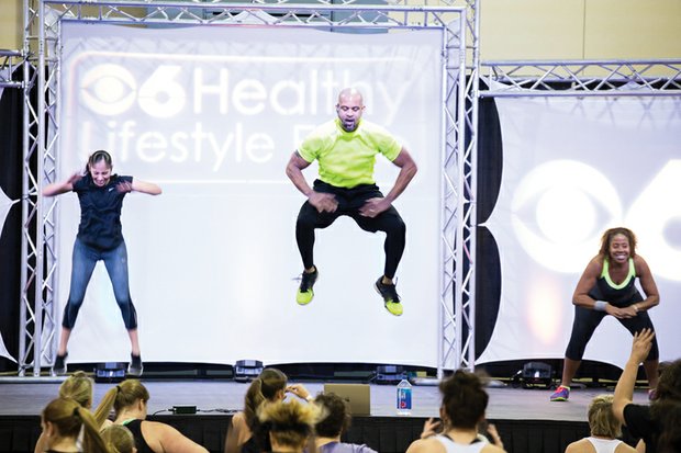 
Fitness fun //
Nationally known fitness guru Shaun T, whose exhilarating dance workouts and fitness routines help people across the country, leaps high in the air last Saturday during a group workout at the 14th Annual CBS 6 Healthy Lifestyle Expo. Hundreds of fitness seekers from Metro Richmond participated in the event at the Greater Richmond Convention Center, which included presentations from other health experts, health screenings and healthy cooking demonstrations. 