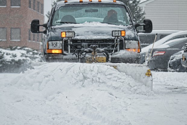 A worker clears a parking lot during the snowstorm that hit the Richmond region three weeks ago.