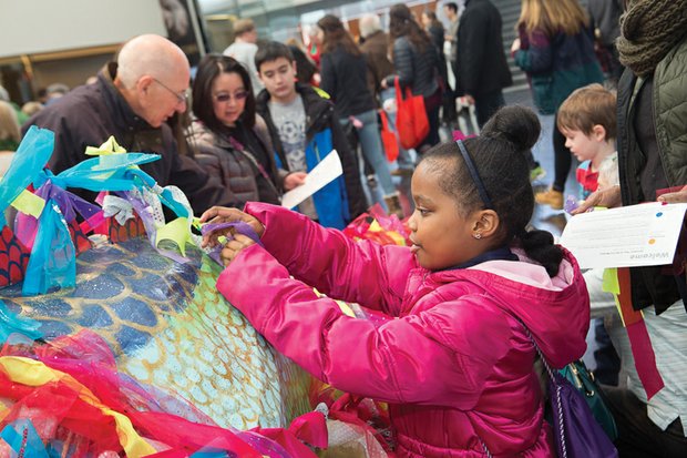 Chinafest!//
GiGi Williams, 6, creatively ties a bow on a papier-mâché dragon at ChinaFest! year of the Fire Monkey. The celebration last Saturday at the Virginia Museum of Fine Arts marked the Chinese New year, which began Feb. 8, by highlighting Chinese art and culture. The festivities included artist demonstrations and performances. youngsters and the young at heart learned about traditional Chinese art by creating their own opera masks, dragon puppets, decorative scrolls and New year’s lanterns.