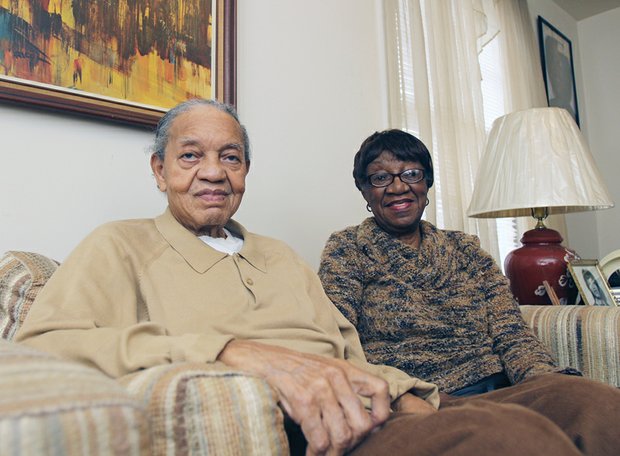 William and Ora Lomax, relax at home as they prepare to launch a combination barber-beauty shop on South Side. 