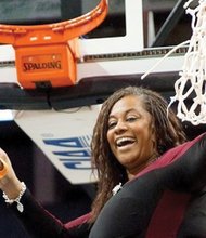 
Coach AnnMarie Gilbert of the Virginia Union University Lady Panthers celebrates the team’s CIAA championship last Saturday by making the final cut to take home the victory net in Charlotte, N.C.