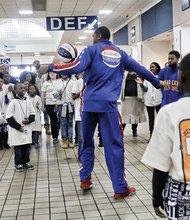 The ‘Thunder Low’ show // Harlem Globetrotters player Thunder Low, center, mesmerizes Richmond’s Carver Elementary School students with his basketball skills. He and other members of the world-renowned basketball team demonstrated their signature dribbling, passing and fancy footwork for youngsters last Thursday at the Greyhound Bus Station on North Boulevard. The team also offered an anti-bullying and teamwork message to the high- achieving students from Carver, which recently was named a Highly Distinguished School by the Virginia Department of Education. The Globetrotters stopped in Richmond on their 90th Anniversary World Tour to perform at the Richmond Coliseum.