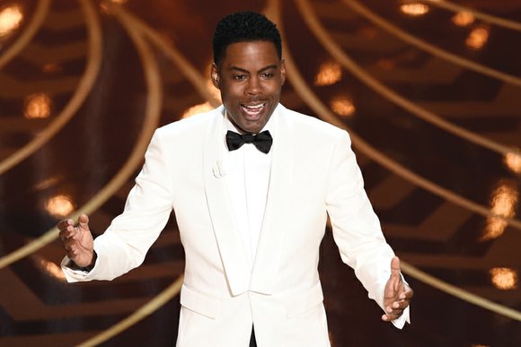 Comedian Chris Rock launched his return stint as Oscar host Sunday by immediately and unabashedly confronting the racially charged elephant ...