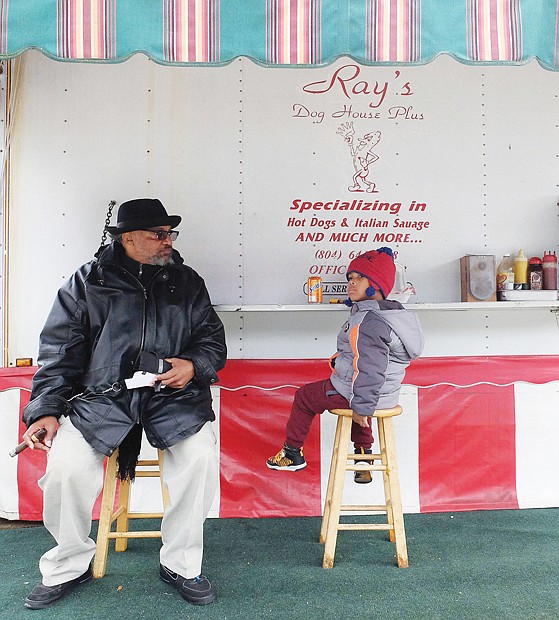 Grandpa’s top dawg // Sayyid Wilson, 4, surveys his surroundings last Friday as he enjoys a day out with his grandfather, Wesley Holmes. The two shared a soda and tasty food at Ray’s Dog House Plus at 401 N. 1st St. in Downtown.