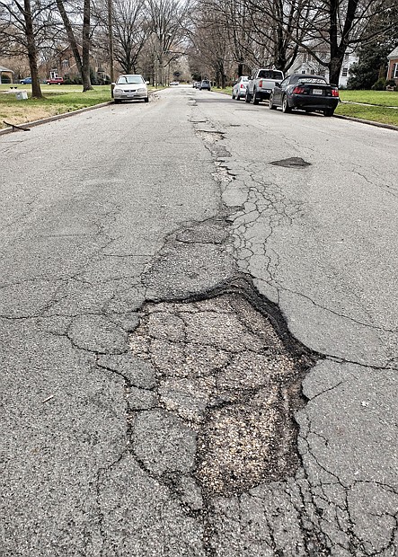 Opportunity time // Loxley Road on North Side is a prime example of the deteriorating fabric of hundreds of miles of city streets. 
Despite a wave of recent pothole repairs, up to half of the city’s aging roadways are rated to be in fair to poor condition. 
In 2012, City Auditor Umesh Dalal reported that the city would need to spend $277 million to bring all of the streets up to good condition. Since then, the city has poured at least $25 million into street maintenance in a bid to achieve Mayor Dwight C. Jones’s goal of repaving 25 percent of neighborhood streets within five years.
Hopes that the city would keep investing between $6 million and $10 million a year into such projects are fading as the city’s borrowing capacity shrinks. 
During the next five years, the city plans to invest about $13.4 million into street maintenance, an average of 
$2.68 million a year. In his report, Mr. Dalal forecast that it would take a minimum of “several decades” for the city to address its street needs. 
