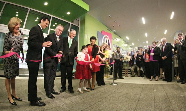 Gov. Terry McAuliffe, third from left, cuts the ribbon at the grand opening ceremony Wednesday. Joining him, from left, Leslie Wyatt, executive director of the Children’s Hospital; VCU President Michael Rao; John DuVal, CEO of VCU Health Systems; Brianna Burke and her mother, Nicole Hauser; and Maggie Raph holding her son, Carter.