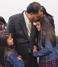 A loving embrace //
Daniel Rodriguez holds his daughters Jasmine, left, and Nicole, close on Sunday afternoon at the fifth annual “Dance of their Own” at the Richmond Justice Center in Shockoe Bottom. The semiformal event provided
the opportunity for selected male inmates to share the afternoon with their daughters and enjoy comedy, dance, games and other activities. The event was part of the Date with Dad Weekend sponsored by the nonprofit Girls for
a Change. Richmond native Chad L. Coleman of AMC’s “The Walking Dead” and Malik Yoba of the hit TV series “Empire” were special guests at the dance.